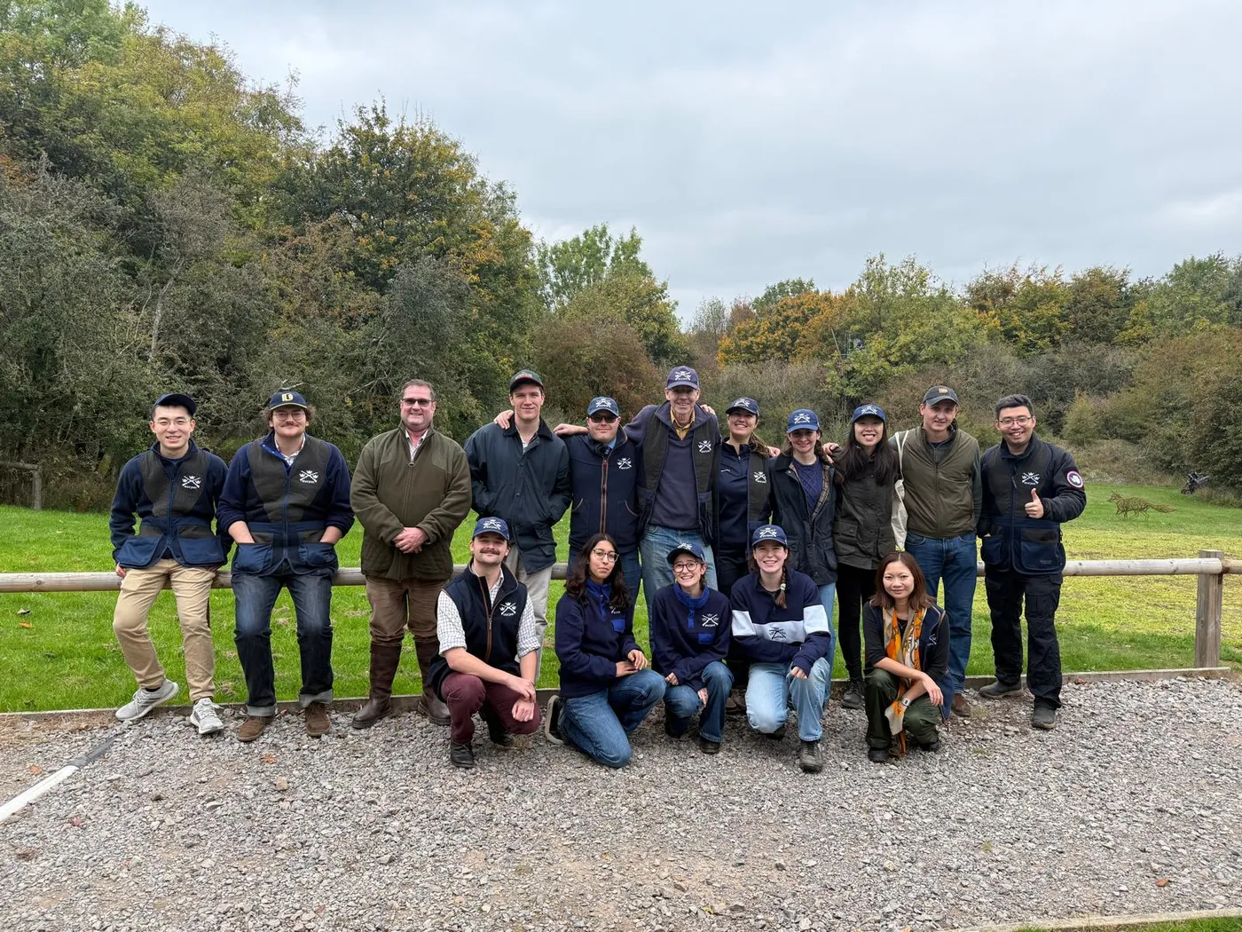 Members in club vests and caps lined up at an autumn shooting ground