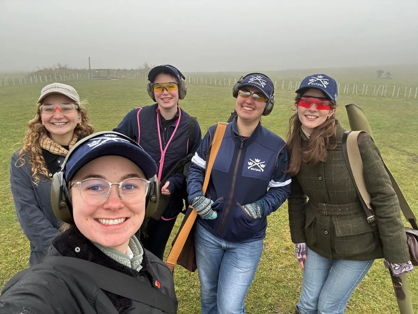 Five members in OUCPSC caps and ear defenders on a foggy shooting ground